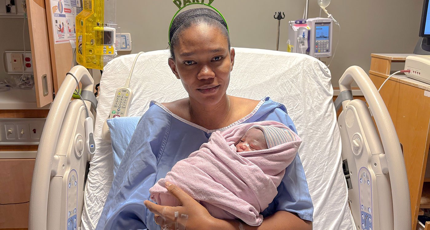 2025 New Year baby held by proud mom Awa in patient bed