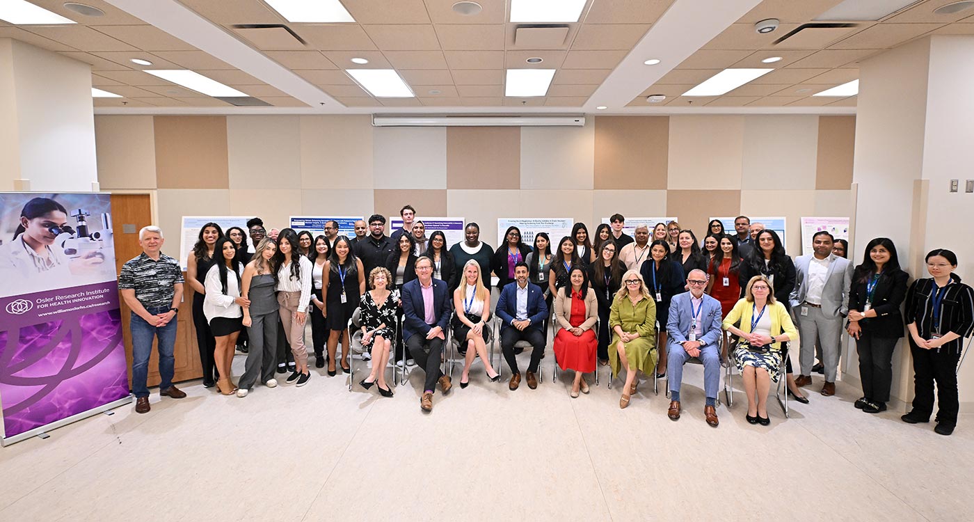 Group shot of elected officials, students and Osler leadership and researchers at the 2024 Summer Student Research Program poster day presentation