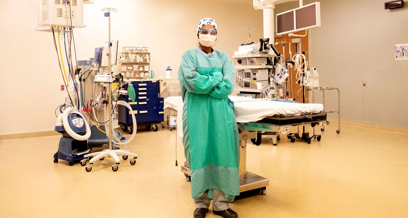 Nurse stands in front of table in the operating room
