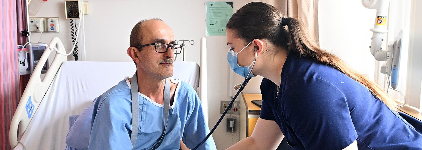 Nurse assists patient with IV